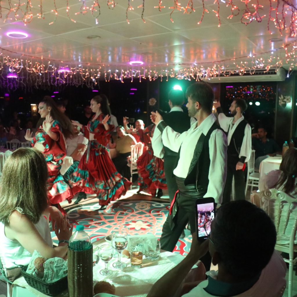 A luxury dinner cruise on the Bosphorus with views of the Bosphorus Bridge illuminated at night